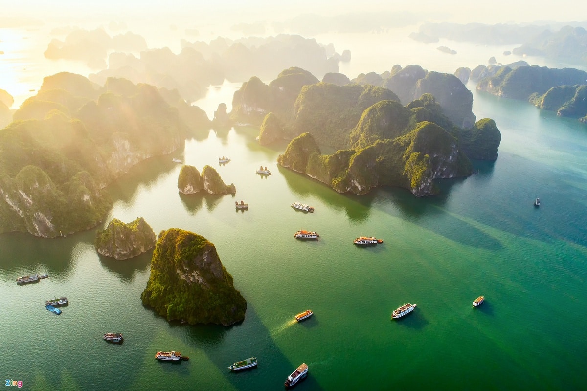 Aerial view of Halong Bay Vietnam at sunrise with limestone karsts and cruise boats