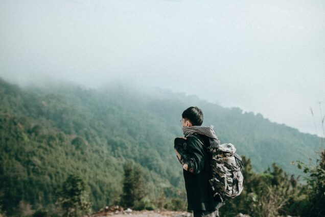 Traveller looking out over misty mountains in Ha Giang